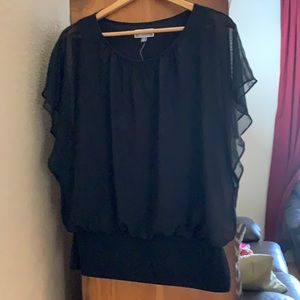 Ladies black blouse with flowing shirt sleeves.